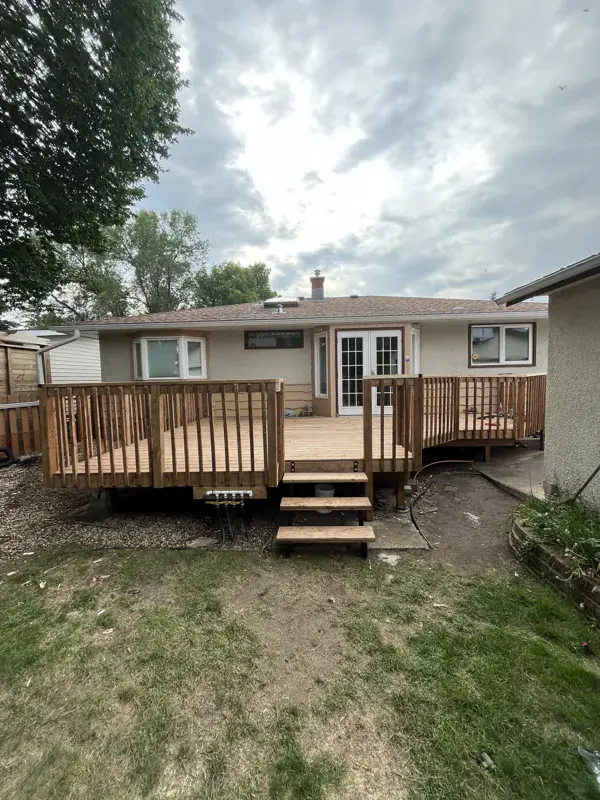 New cedar deck with stairs on the back of a house